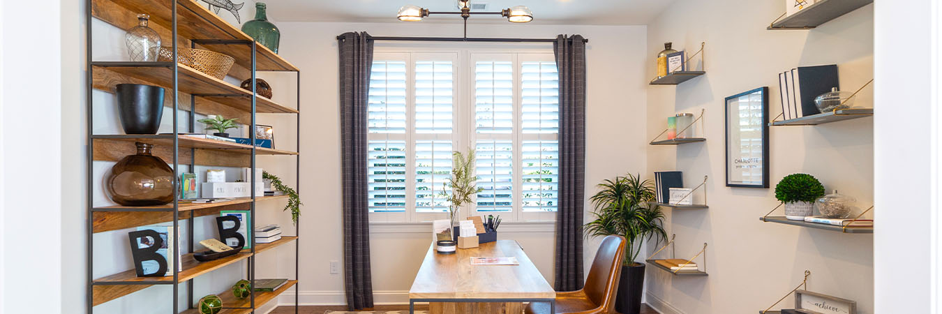 White Polywood shutters on a window in a stylish home office