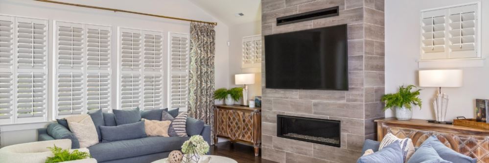 Plantation shutters in Glencoe family room with fireplace