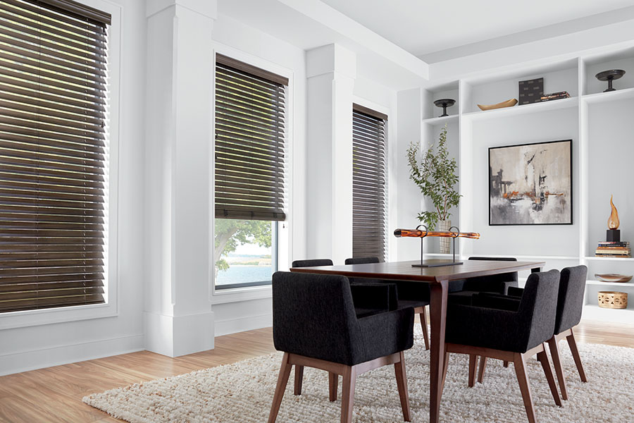 It's easy to customize premium blinds to coordinate with your home decor. Dark brown blinds on windows in a dining room